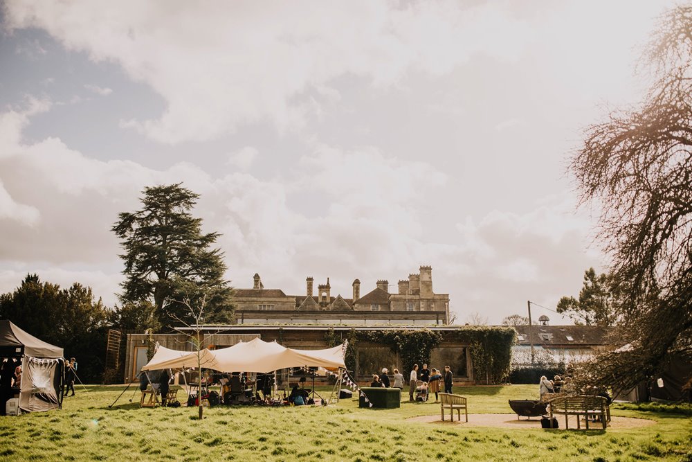 Festival wedding fair with outdoor vendors and Earth Village stretch tent at elmore court in the cotswolds