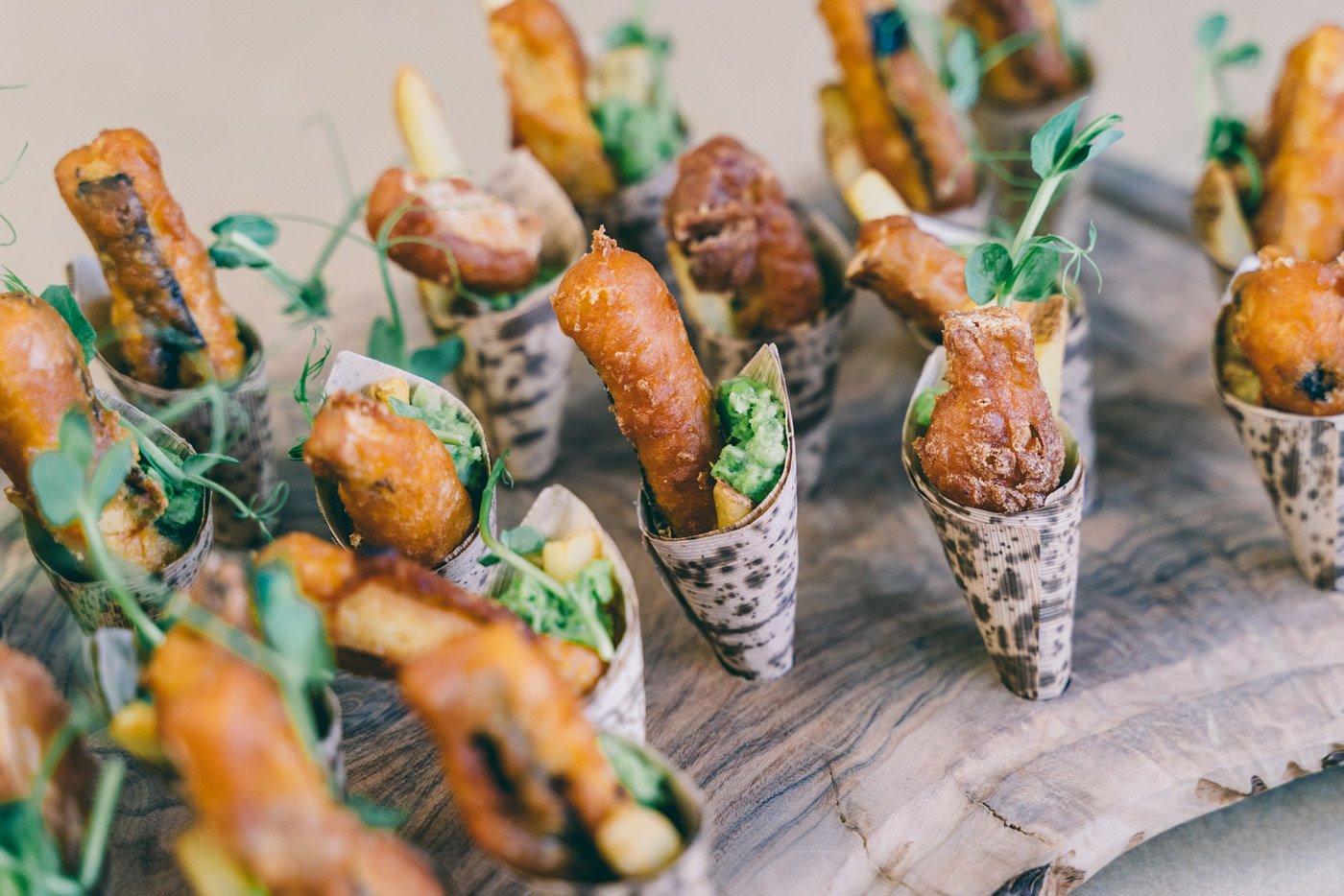 Mini Vegan fish and chip cones wedding canapes on a wooden board at an Elmore Court wedding fair