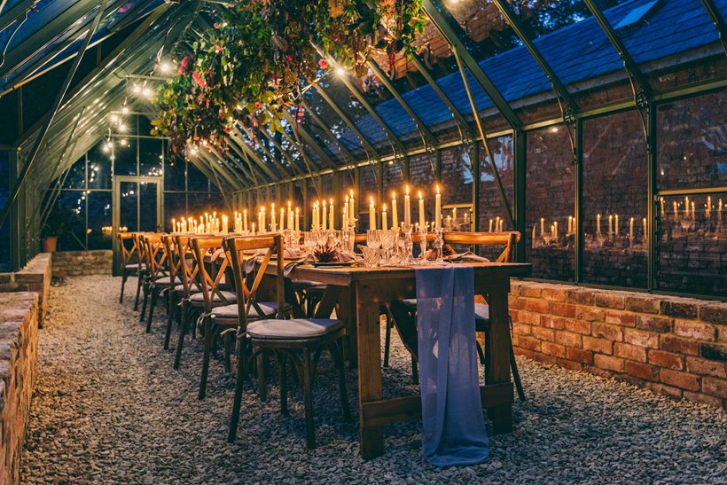 A candlelit dinner in a glasshouse, wedding inspiration by Elmore Court