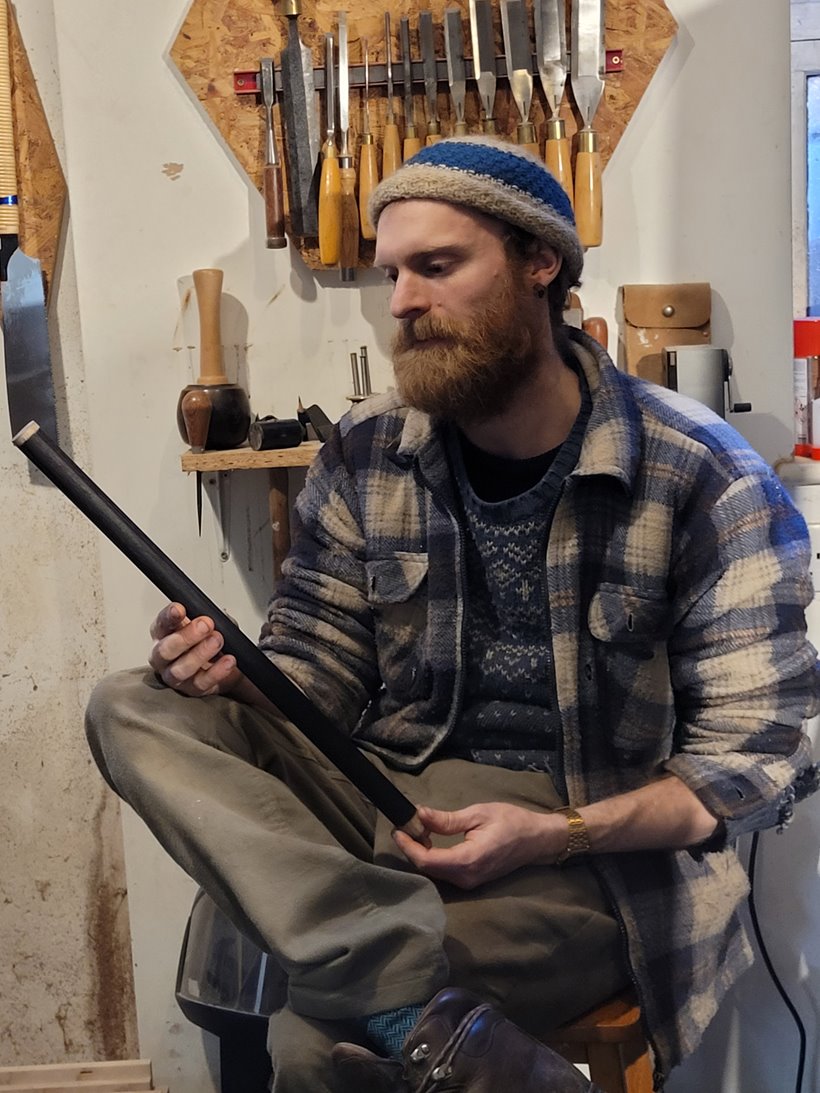 Carpenter examining some timber spindles for a custom built trundle bed