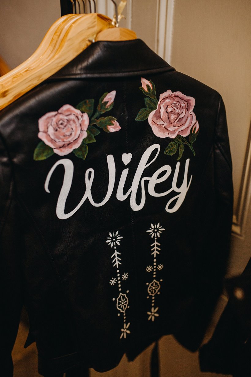 This Rock n roll bride wore a leather jacket with wifey painted on the back at her rocking real wedding at elmore court