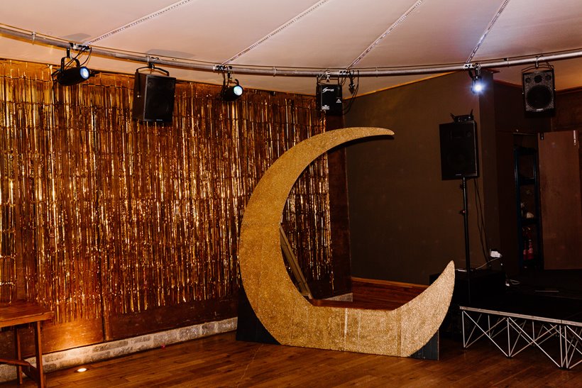 Giant gold moon and gold curtain for celestial wedding at stately home elmore court