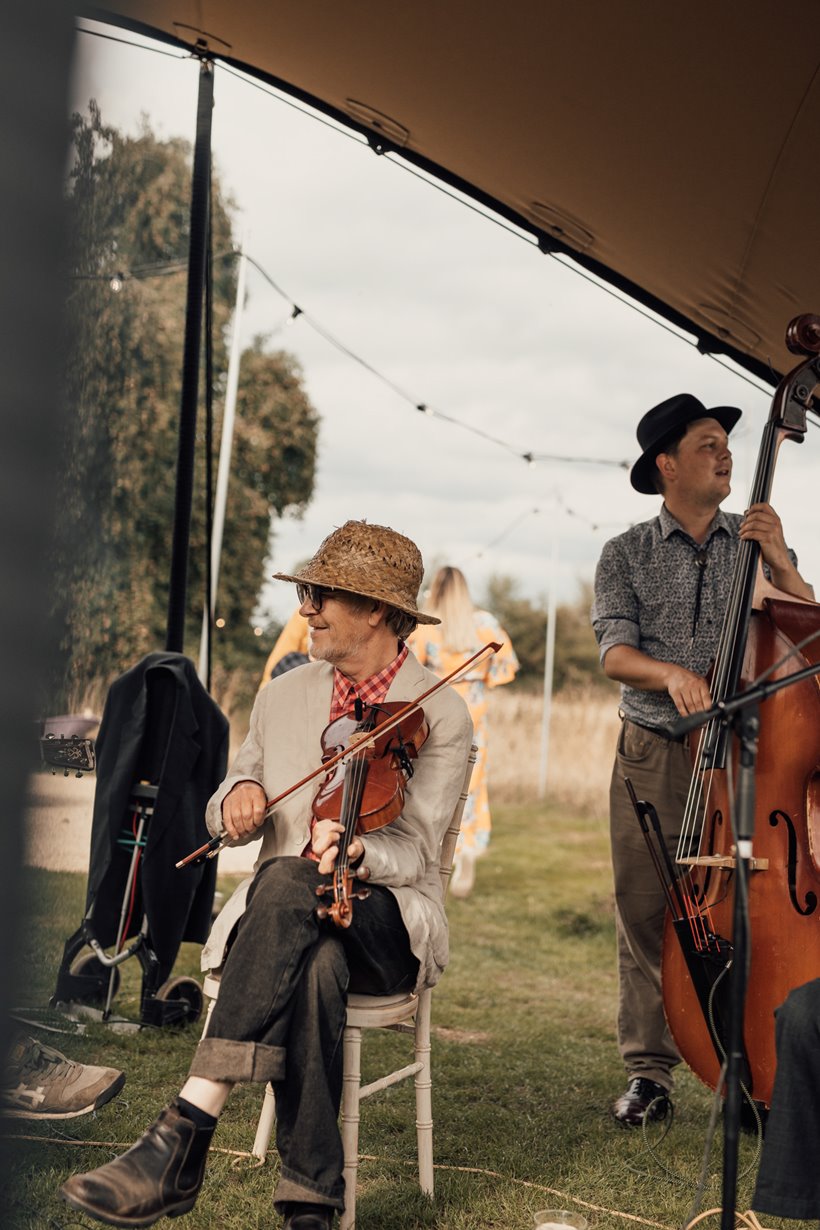 Cut a shine festival band playing a wedding under stretch tent at wedding venue elmore court