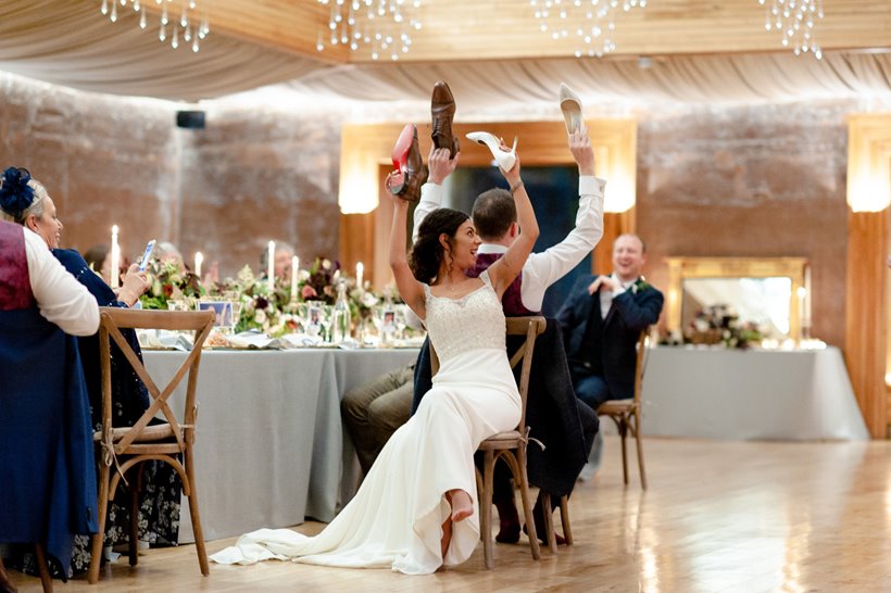 Bride and groom having fun at their micro wedding reception dinner