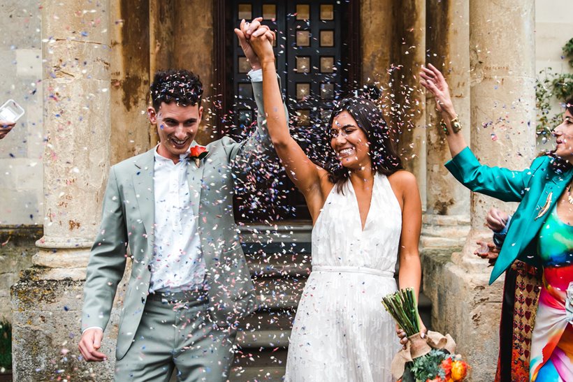 micro wedding couple happily married with confetti