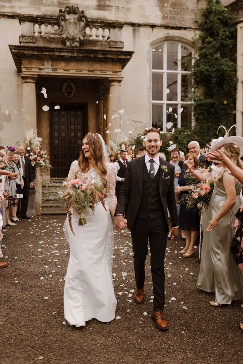 confetti throwing bride and groom happily married at stately home elmore court