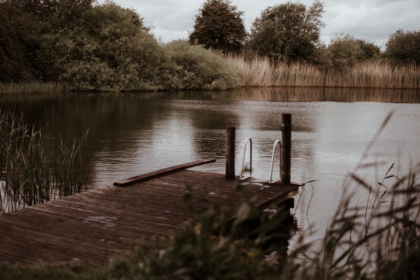 Swimming lake at rewilding wedding venue elmore court is open all year round for swims in spring fed water surrounded by countryside 