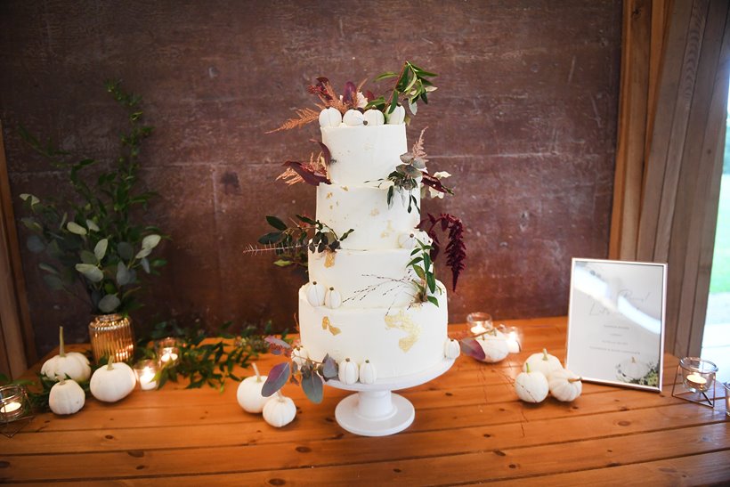 4 tier autumnal wedding cake with 4 flavours including pumpkin spice and decorated with mini fondant pumpkins for an october wedding