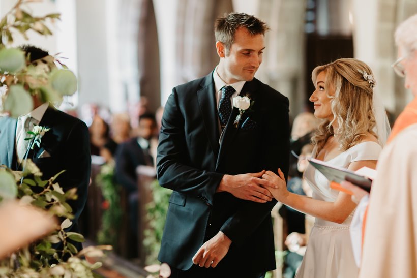 Candid shot of bride and groom during wedding ceremony 