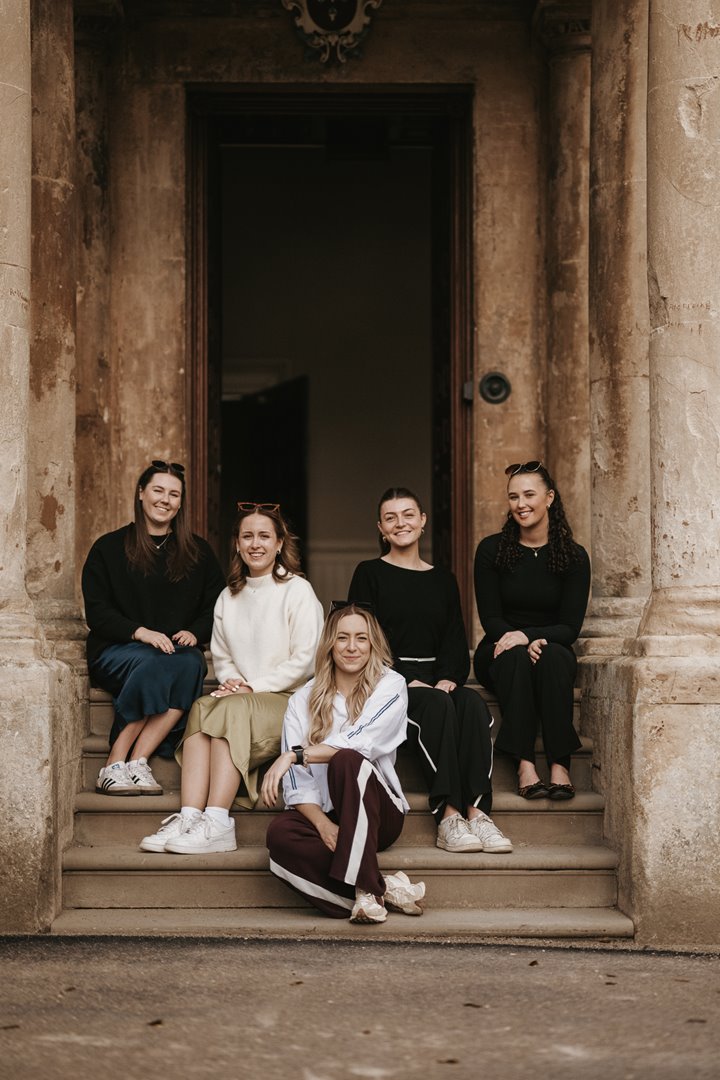 Team E pictured on the steps of Elmore Court 