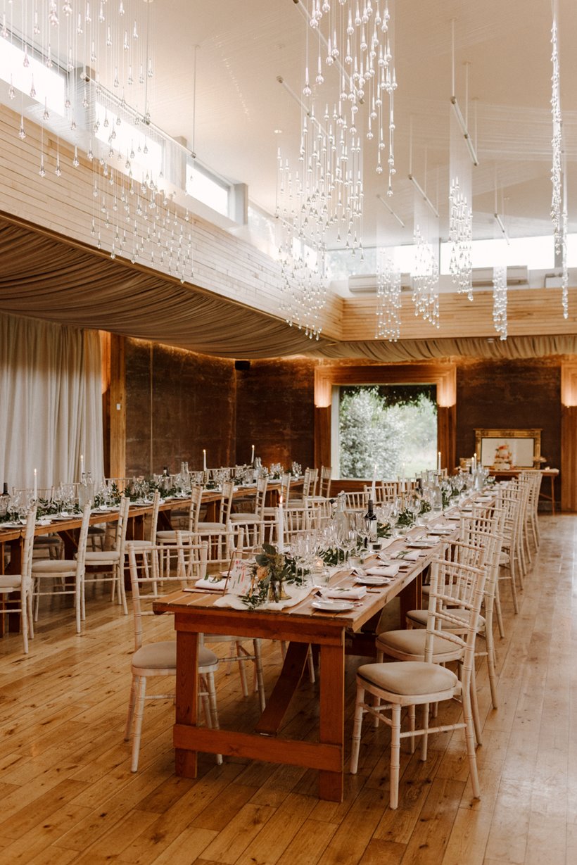 September wedding reception decor laid out on long banquet tables in sustainable wedding venue elmore court