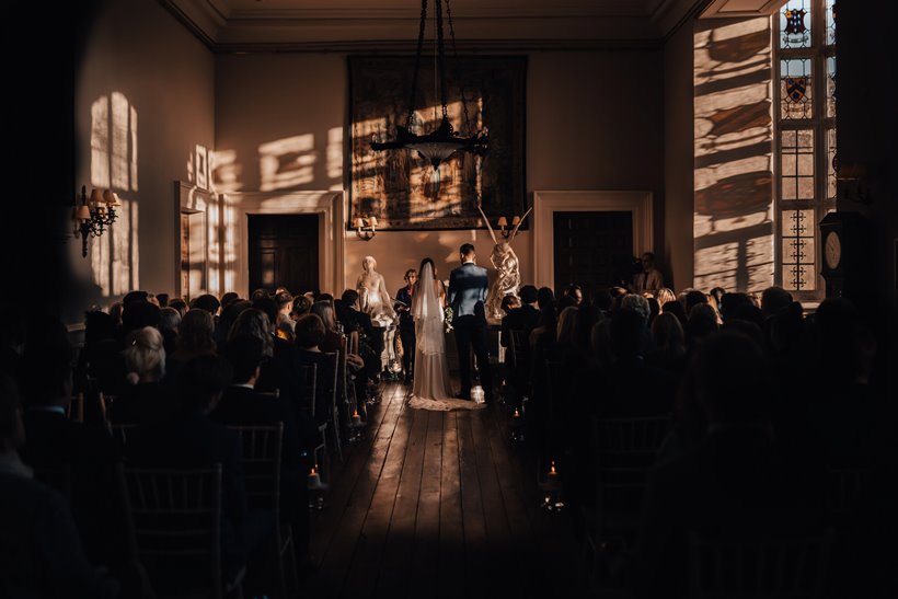 Autumn wedding light beautiful stained glass patterns in the hall at elmore court