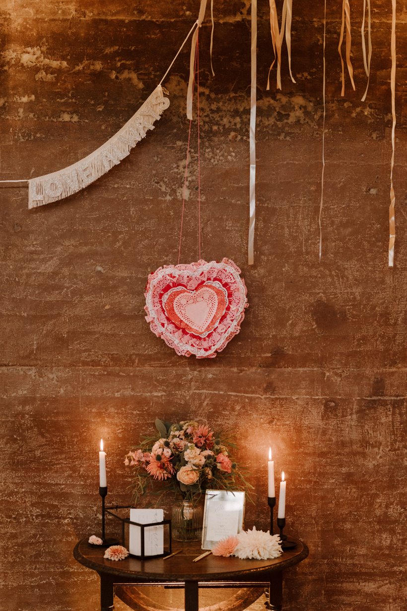 Pretty pink details at cool modern wedding pink pinata and ribbons in september at sustainable wedding venue elmore court