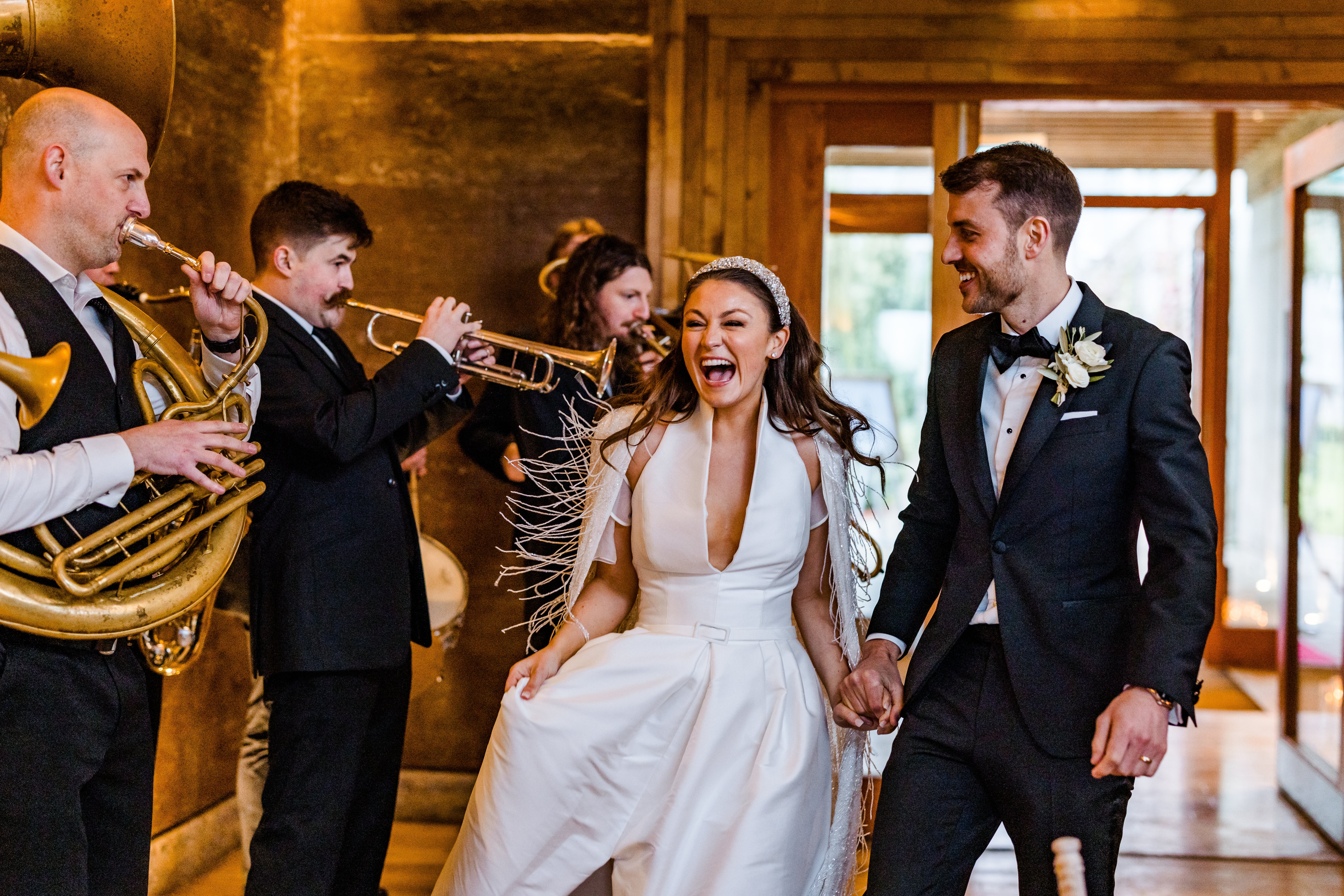 Couple entering the gilly flower with a brass band