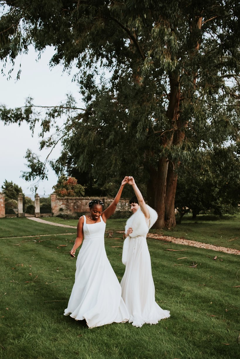 two lovely brides in a walled garden of a stately home in gloucestershire 